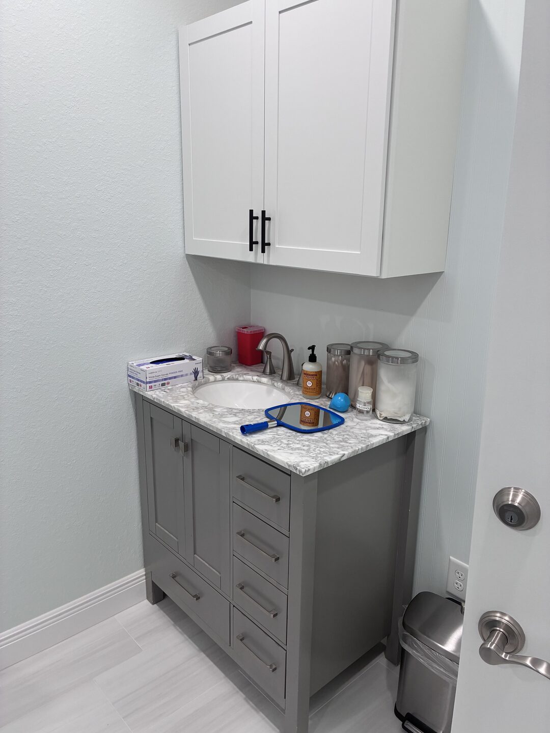 A treatment-area sink and storage cabinet