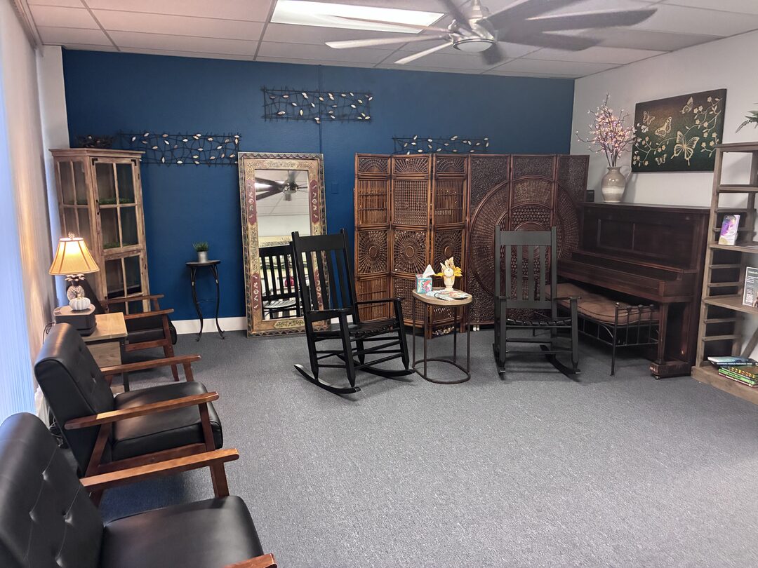 The waiting room at Eau Gallie Medical Center, with rocking chairs and a piano